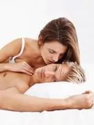 séduisante jeune femme et homme faisant l'amour au lit