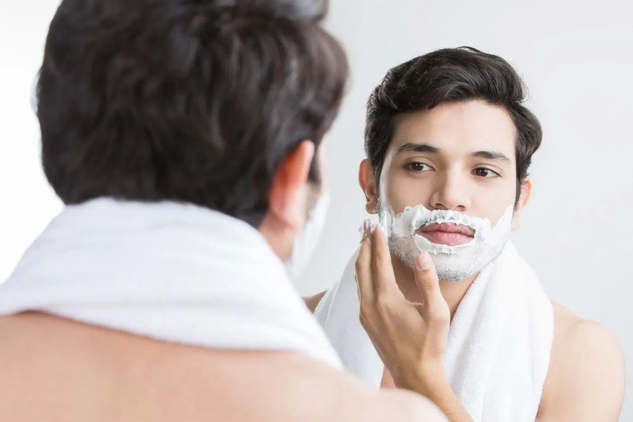 man shaving in the bathroom