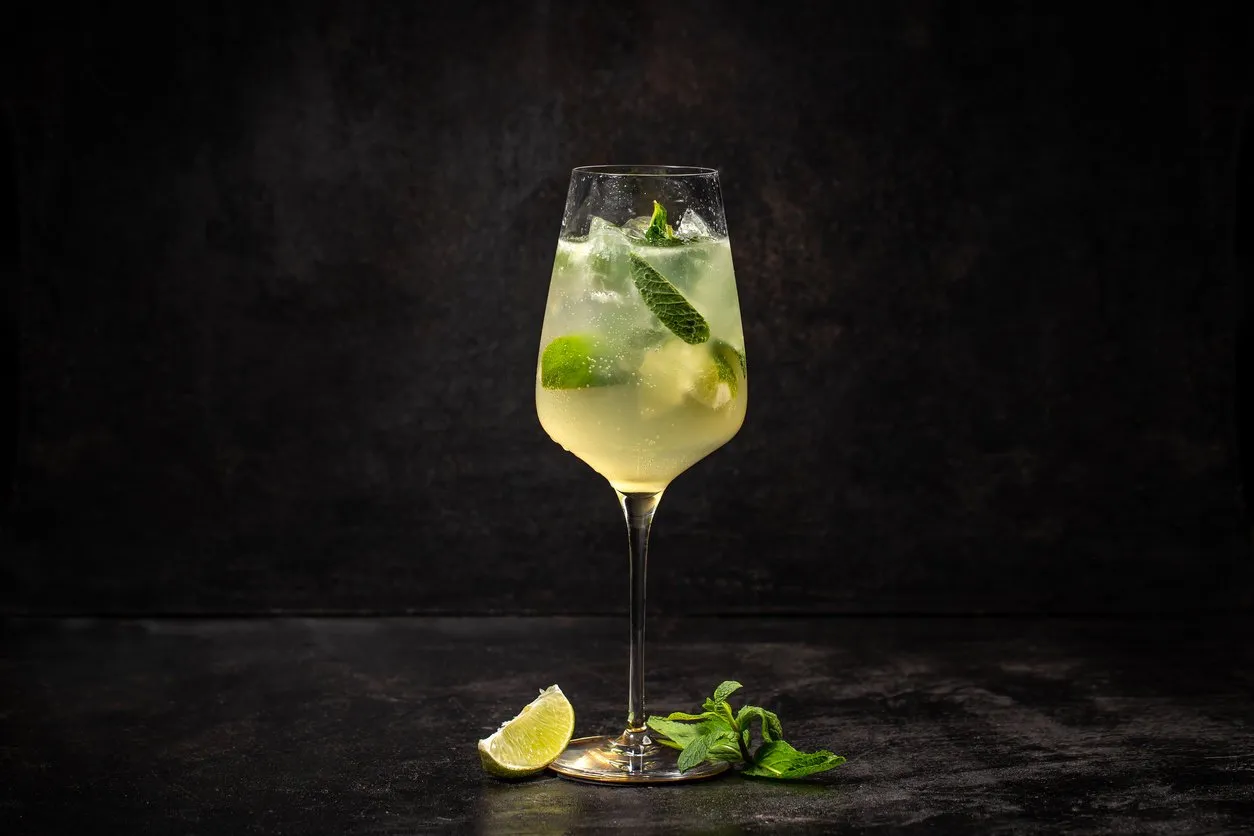 summer cold drink with lemon, mint and ice on black background