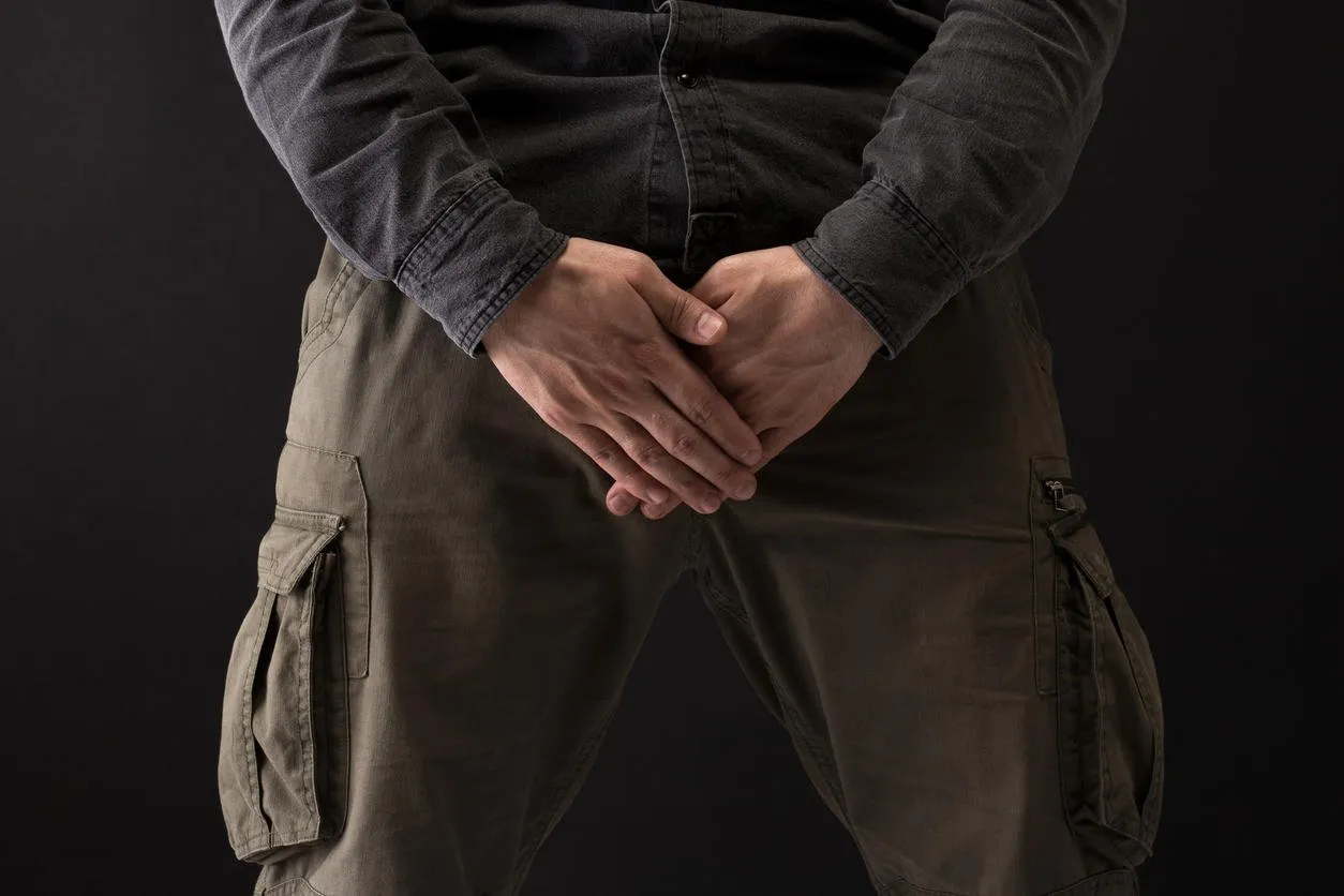 sexual problem, man holding genital area