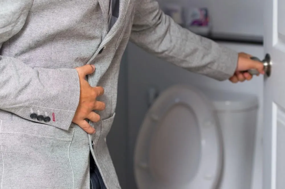 a man holding his penis with on the wants to go to the toilet
