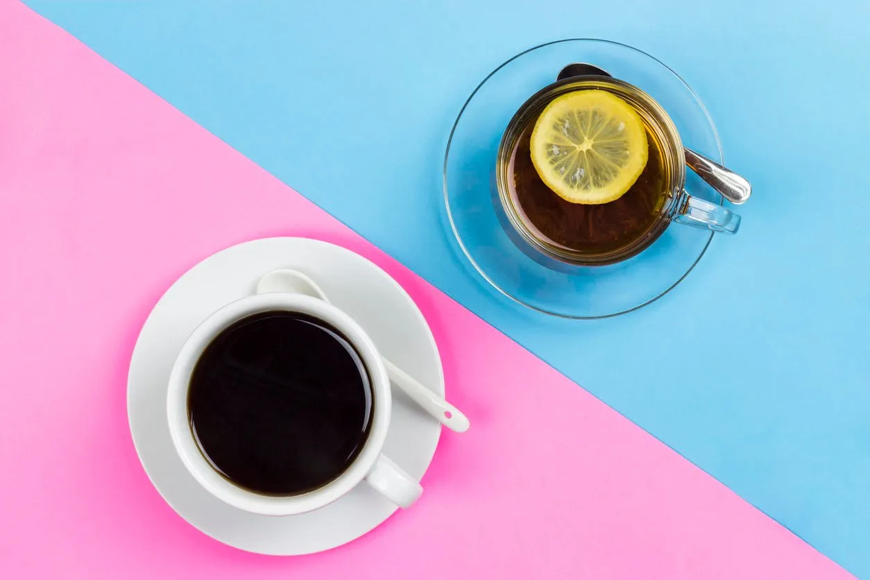 cup of tea with lemon and a cup of coffee on a wooden surface, the choice between coffee and tea