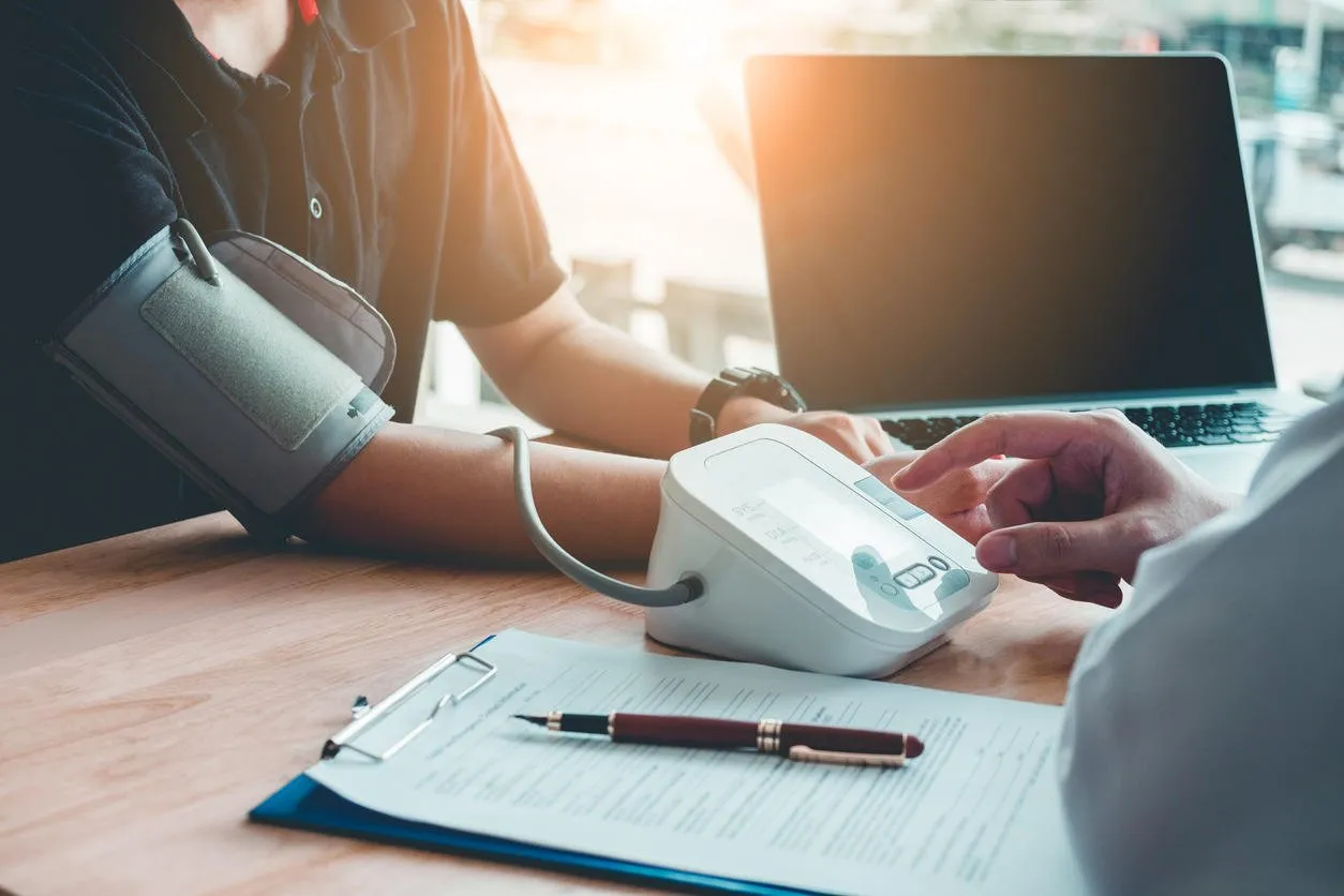 doctor measuring arterial blood pressure woman patient on right arm health care in hospital