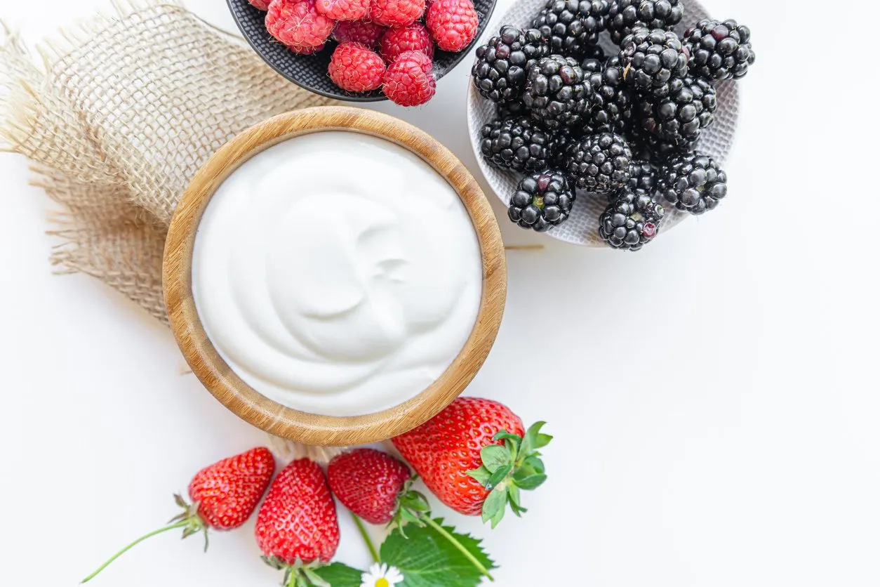 yogurt in a bowl with spoons,healthy breakfast with fresh greek yogurt and strawberry on background