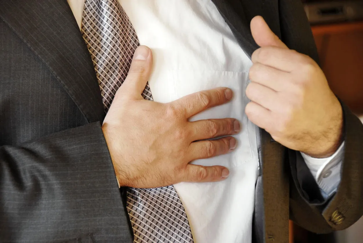 businessman hand on chest, stressful job troubles