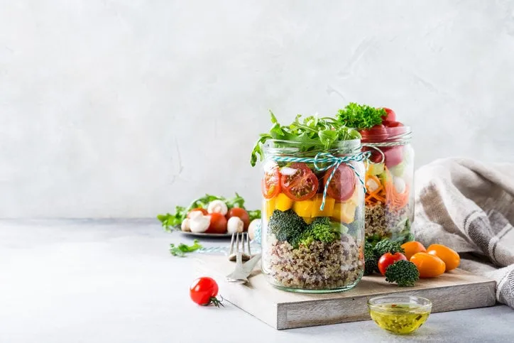 homemade salad in glass jar with quinoa and vegetables healthy food, diet, detox, clean eating and vegetarian concept with copy space