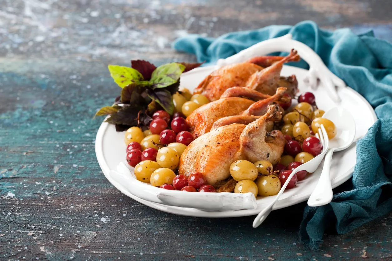 roasted quails with baked grapes, selective focus