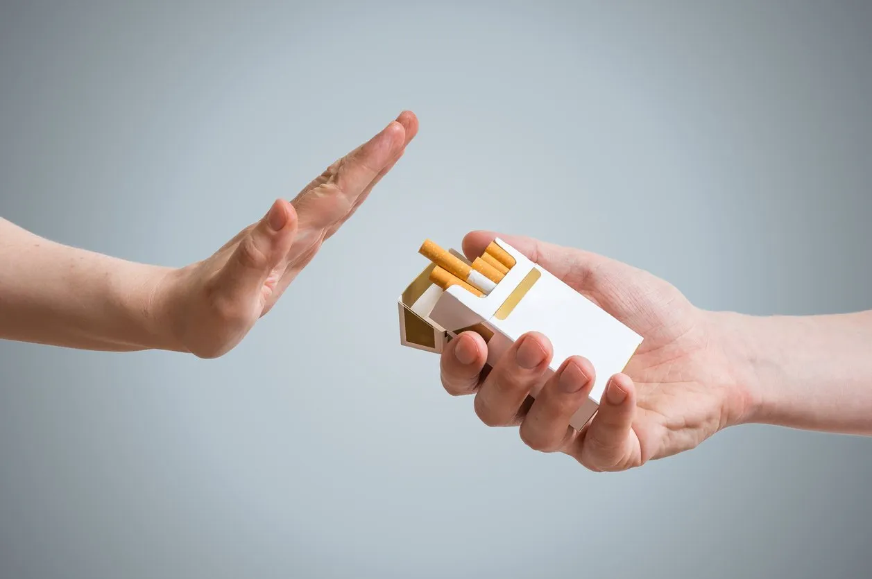 quitting smoking concept hand is refusing cigarette offer