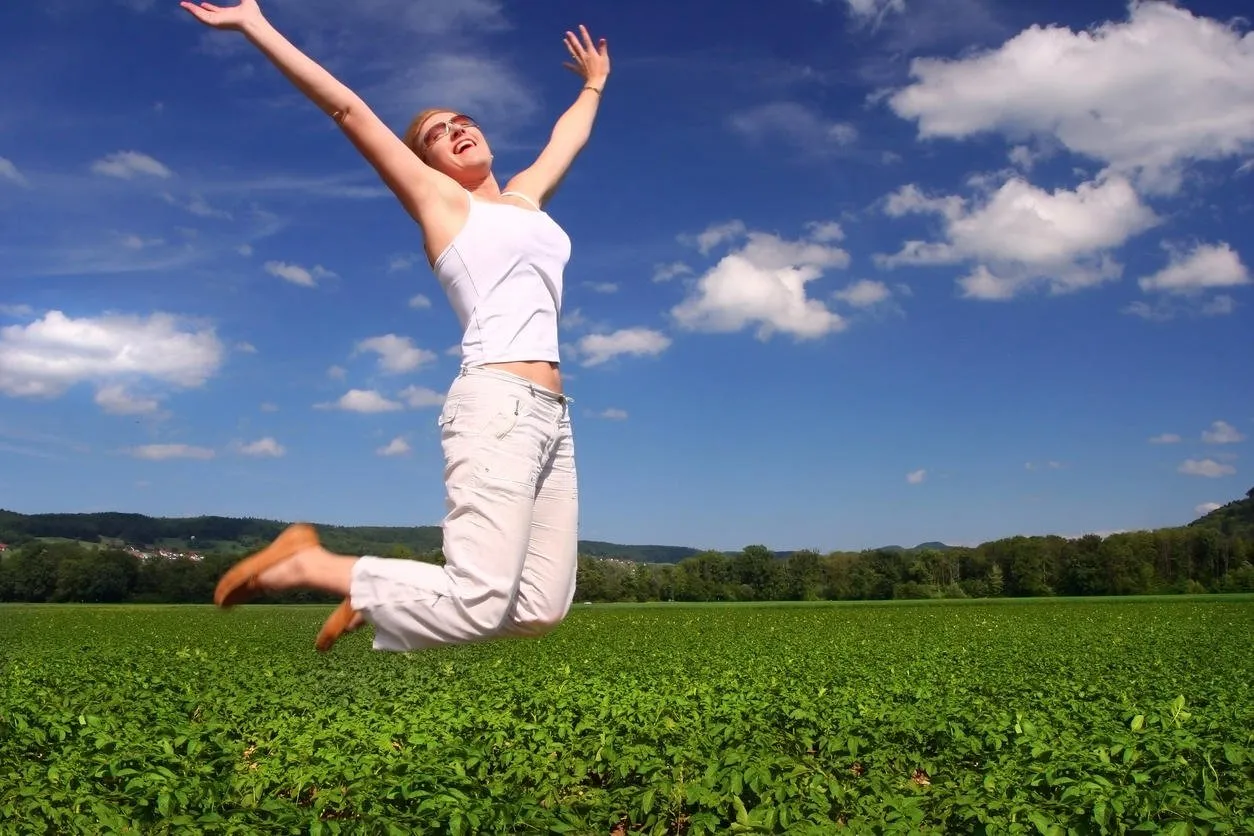 jumping girl on the green field