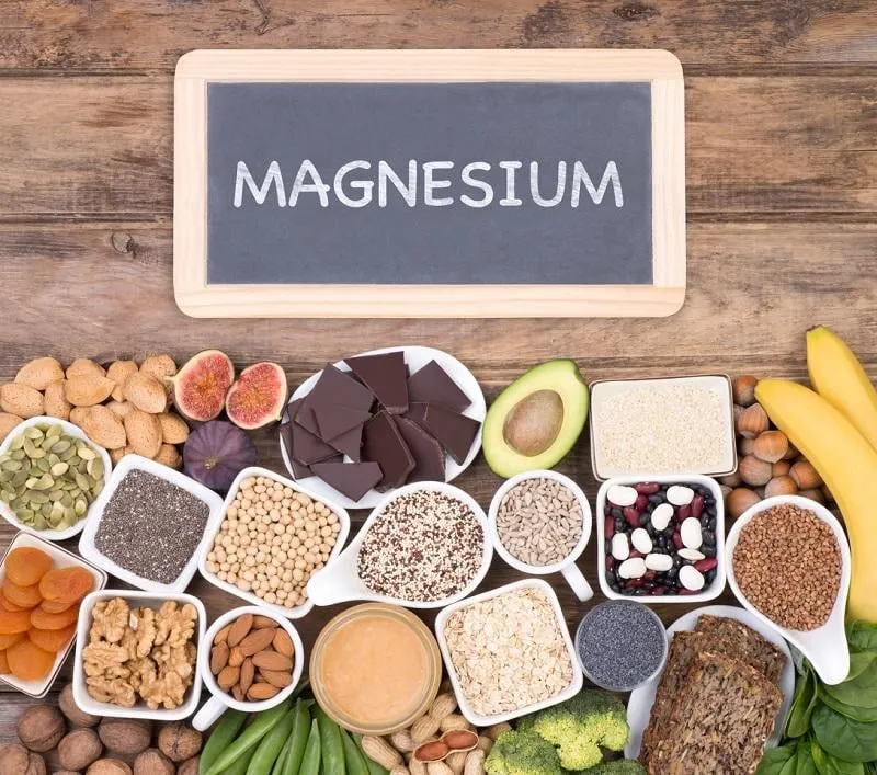food rich in magnesium, top view with a small blackboard