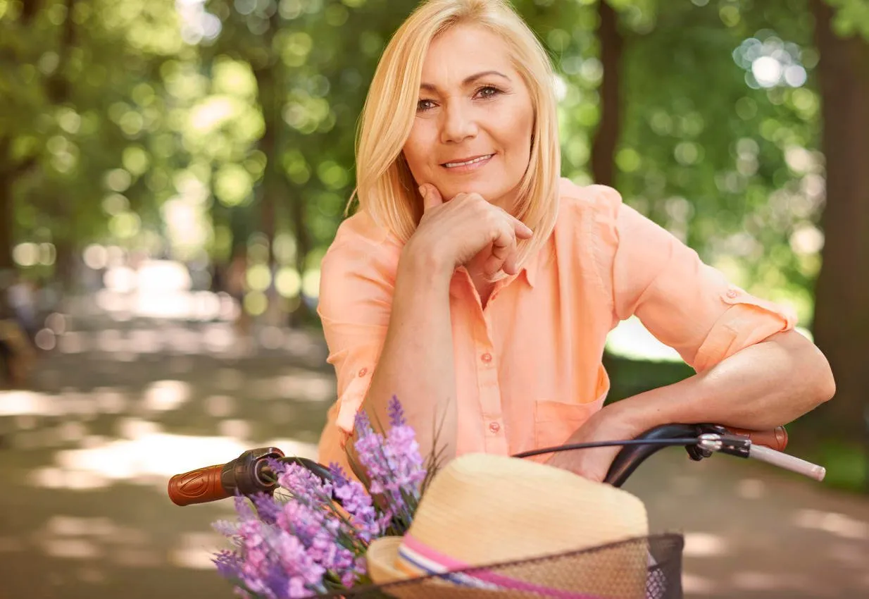 happy mature woman on the bike
