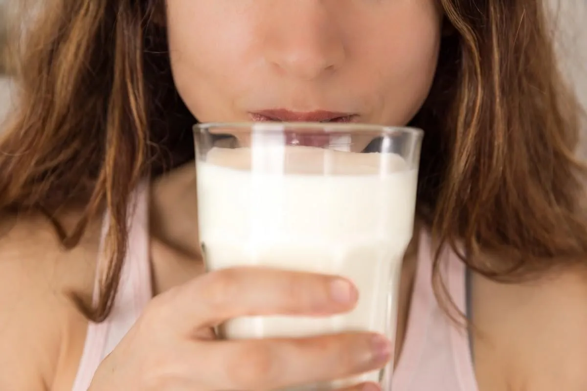 close up of woman drinking milk
