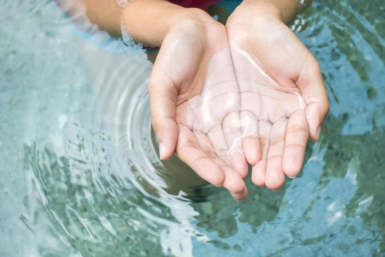 clear natural water in woman hands