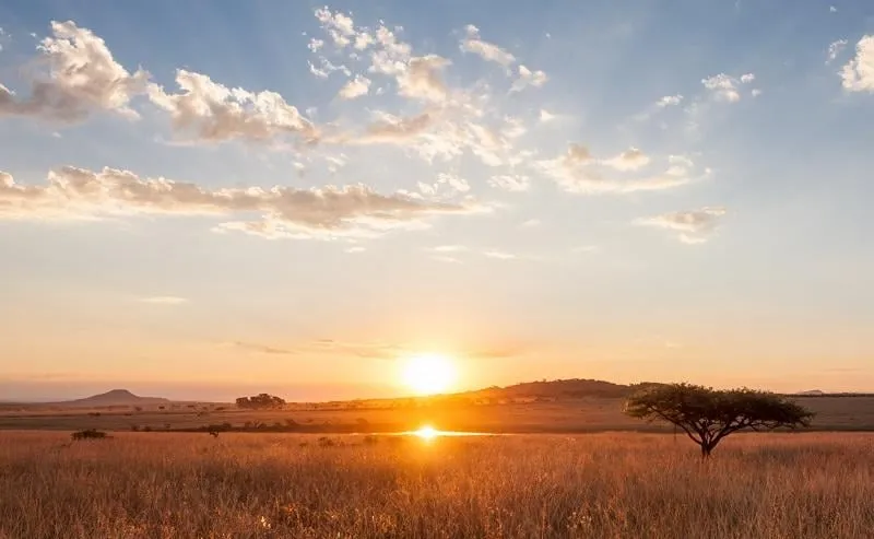 sunset reflected in a waterhole on the plains of south africa in kwazulu natal