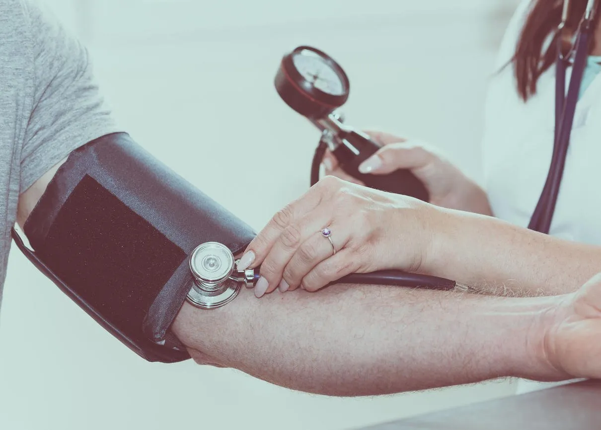 doctor measuring blood pressure of patient