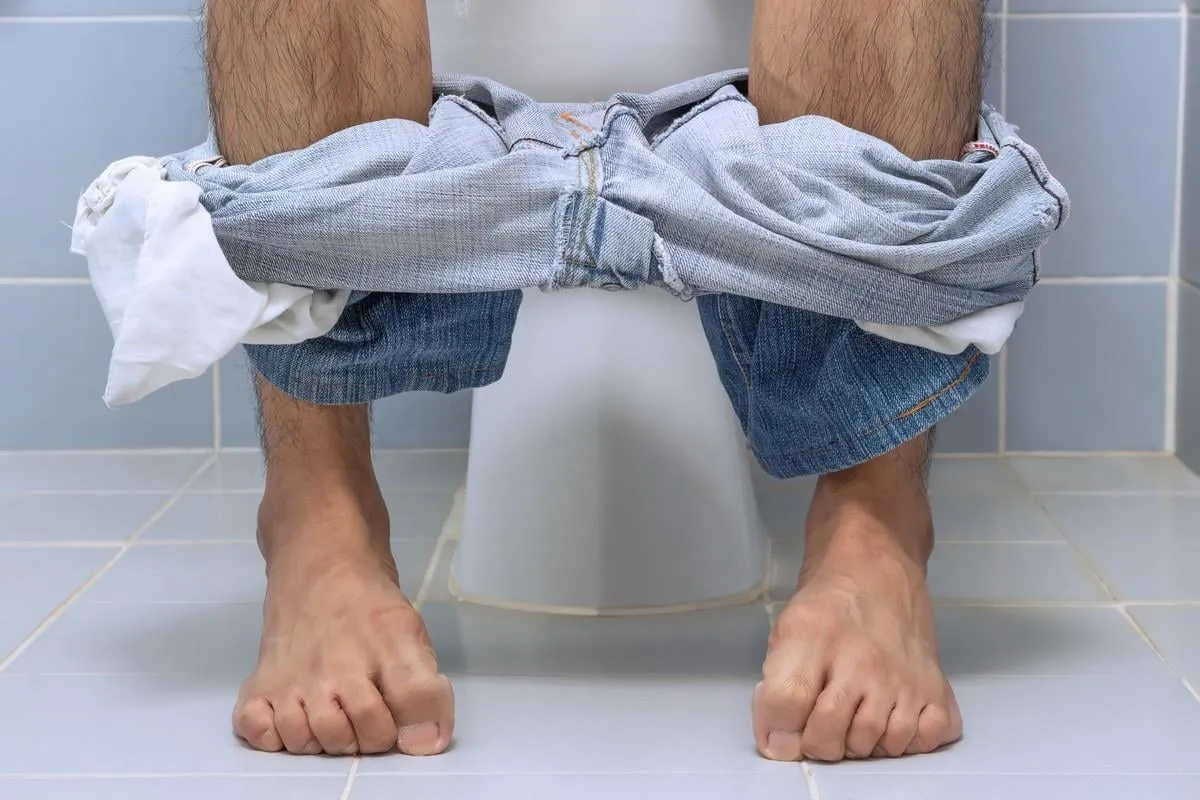 man sitting on toilet, diarrhea