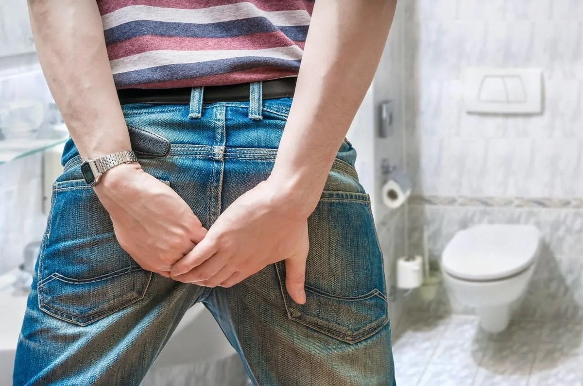 man suffers from diarrhea in restroom