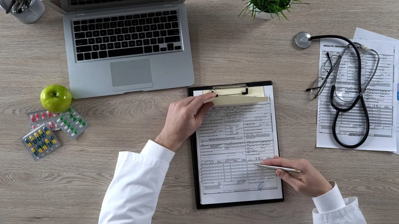 family doctor signing prescription and health insurance form, health care reform