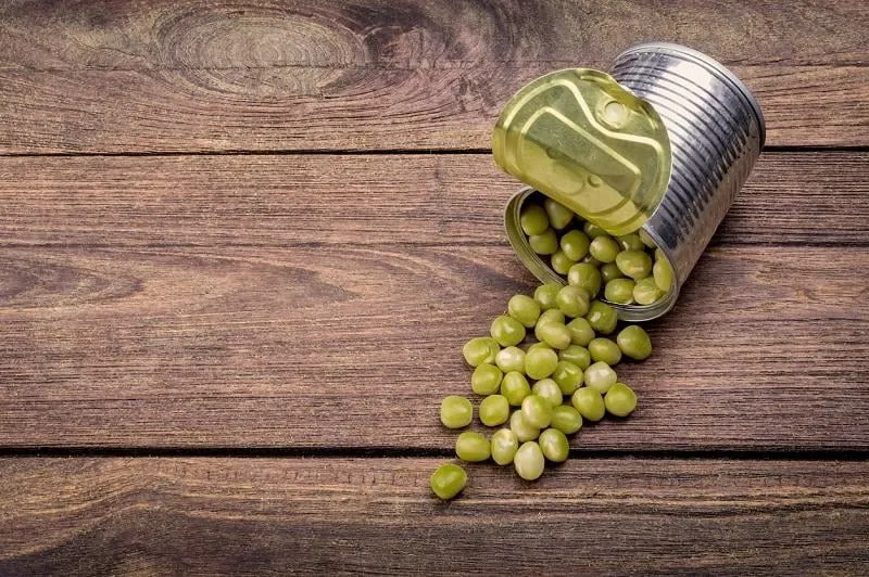 canned peas on vintage wooden background