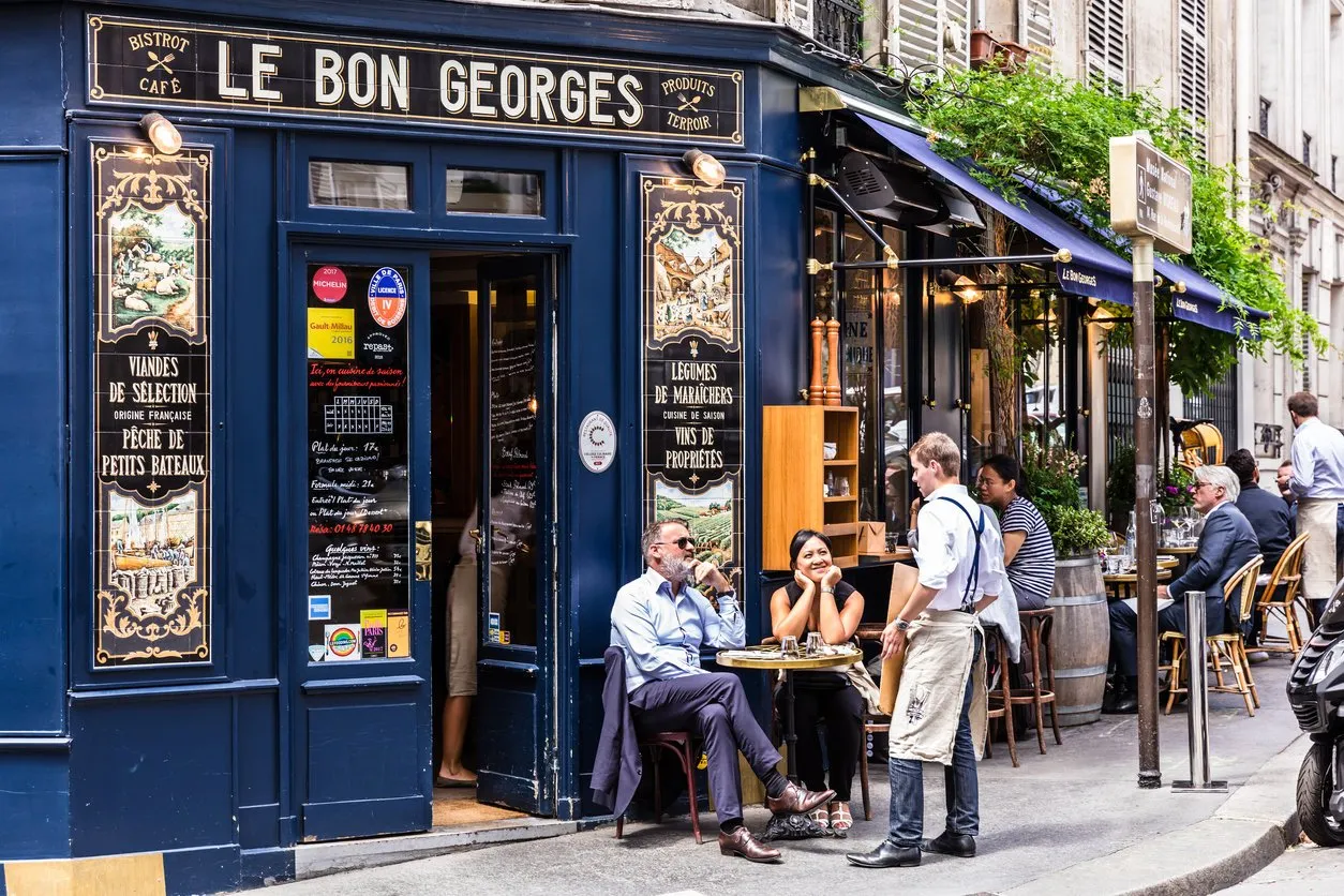 paris, france - june 16, 2017  the charming cafe le bon georges parisians and tourists enjoy food and drinks at the street french cafe