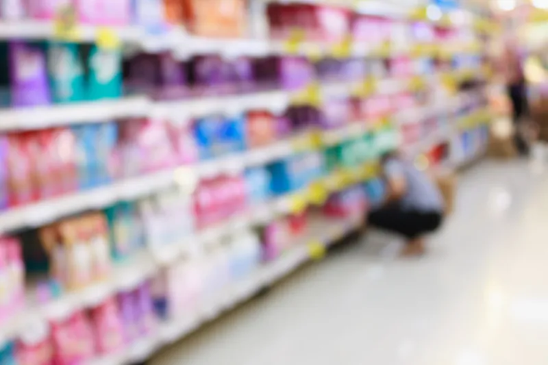 detergent shelves in supermarket or grocery store blurred background