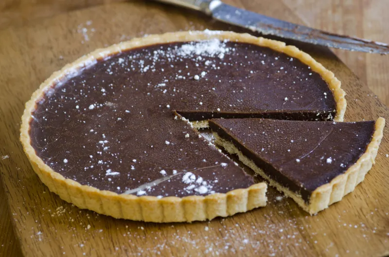 homemade chocolate tart on a wooden board