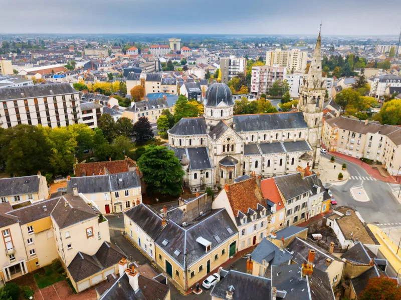 aerial view of ancient church notre-dame in french commune of chateauroux on background with peculiar townscape