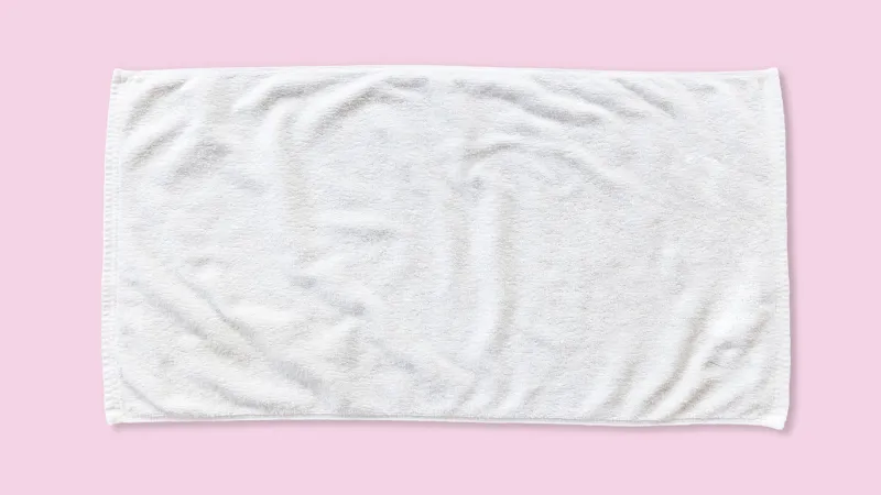 white beach towel mock up isolated with clipping path on pink background, flat lay top view