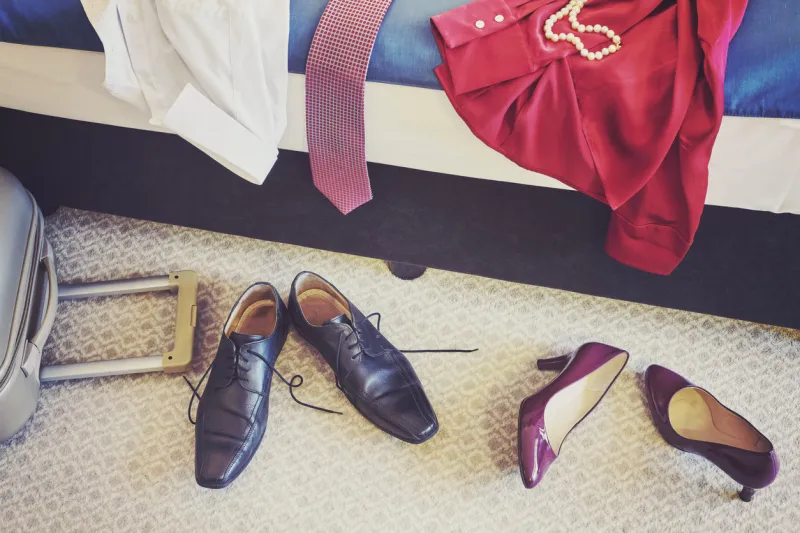 female and man footwear and clothing in a hotel room, vintage toned conceptual picture