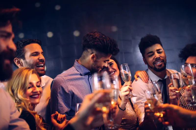 cropped shot of an happy couple having fun with friends in the nightclub