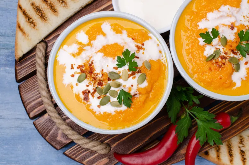 pumpkin cream soup with spices on a bowl on a wooden background selective focus