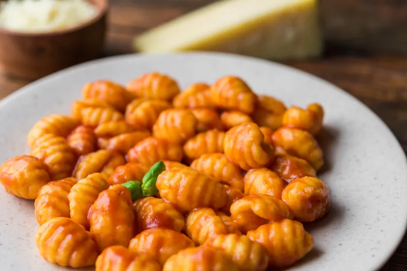 gnocchi with tomato sauce, basil, and cheese, traditional italian pasta food made of potatoes and flour