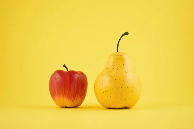 yellow pear and red apple on a yellow background fruit home decor plastic decorative fruit
