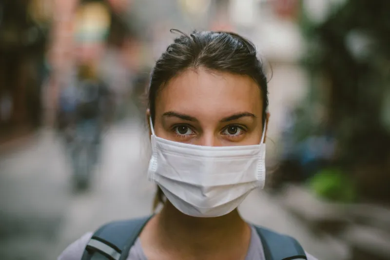 young woman wearing face mask in the street