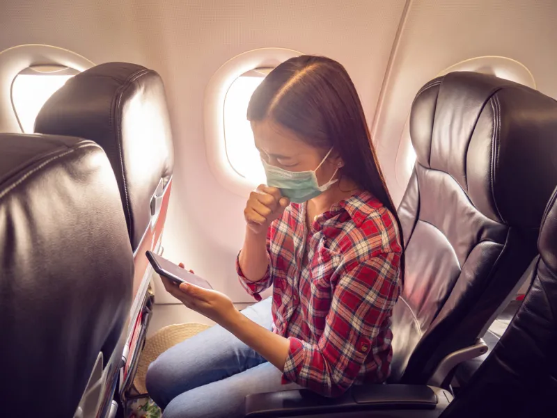 asian tourist feeling sick, coughing ,wearing mask to prevent during travel time by airplane for protect from the new coronavirus 2019 infection outbreak situation