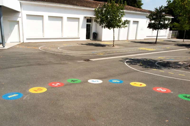 preschool building exterior with playground on a sunny day