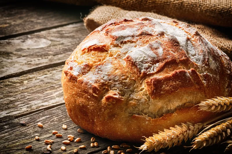 freshly baked traditional bread on wooden table