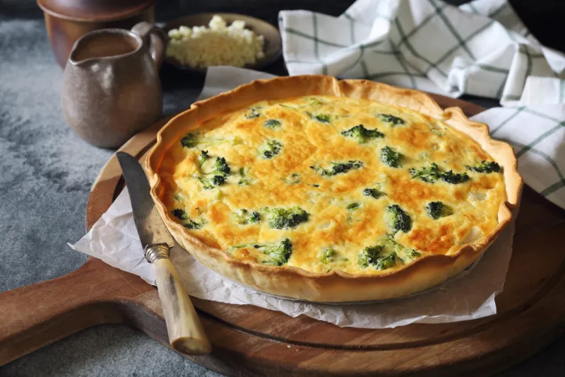 french cuisine, intact quiche with broccoli and grated cheese
