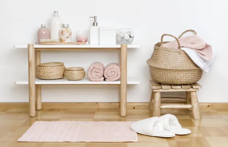 bathroom partial interior with wooden shelf, stool and spa products