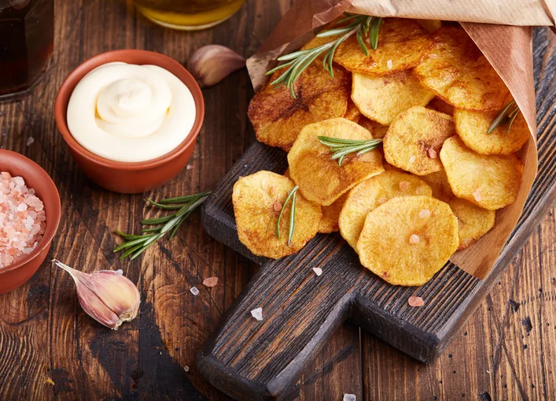 crispy potato chips slices of potato, roasted with sea salt and rosemary delicious snack served with sauce fast food