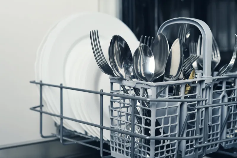 clean cutlery and plates after washing in dishwasher machine