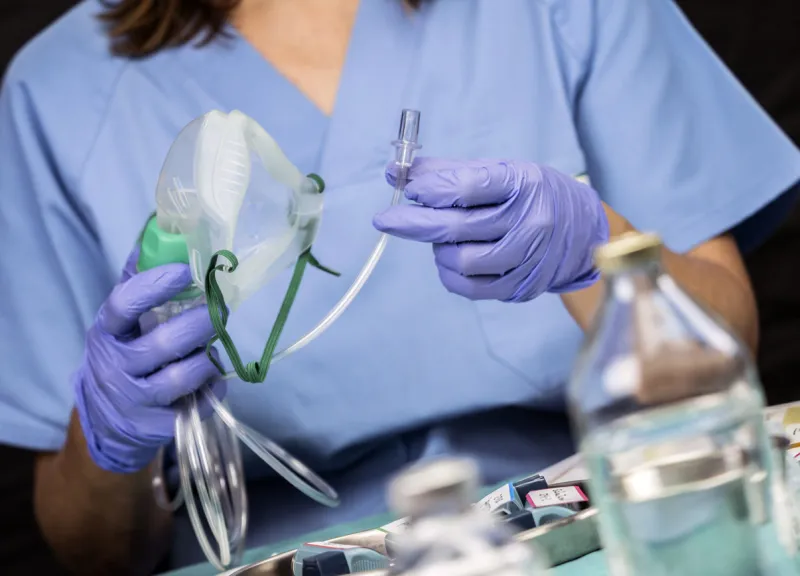 nurse prepares oxygen mask in hospital, conceptual image