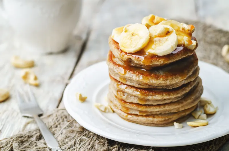 banana cashew pancakes with bananas and salted caramel sauce the toning selective focus