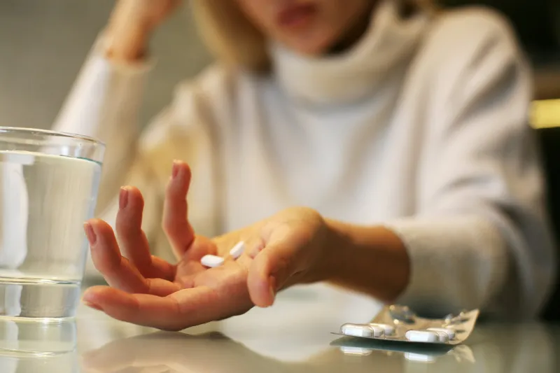 close up of woman hands holding a pills