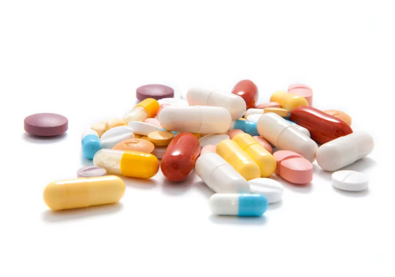 a choice of capsules and tablets on white background