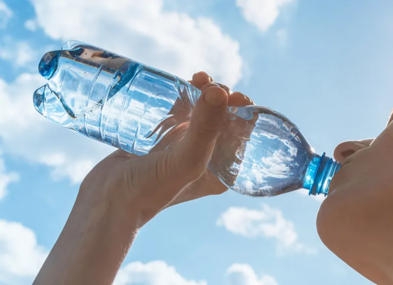 woman drinking water after her workout