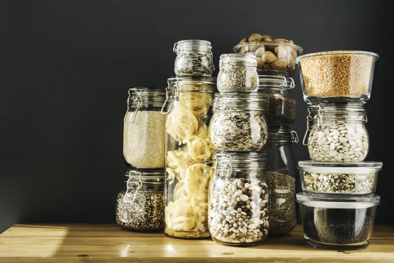 banner with assortment of grain products and pasta in glass storage containers on wooden table healthy cooking, clean eating, zero waste concept balanced dieting food copy space