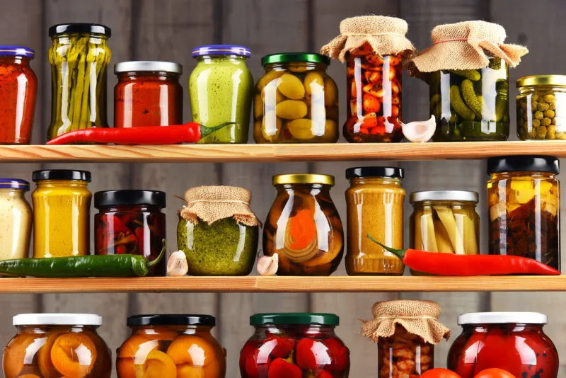 jars with variety of pickled vegetables preserved food