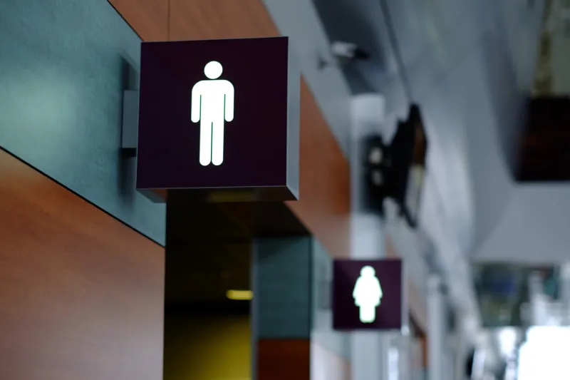 entrance to the male and female toilet sign in airport