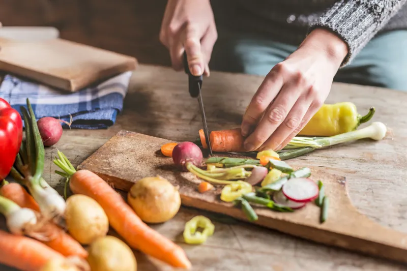woman chopping food ingredients